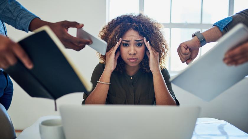 Women stressed with people handing her things